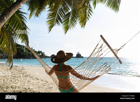 Rear View Of Woman In Bikini Sitting On Beach Hi Res Stock Photography And Images Alamy