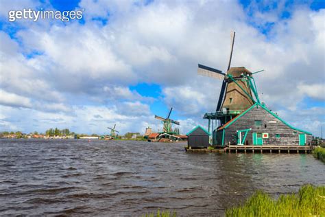 Traditional Dutch Windmills At The Zaan River In Zaanse Schans Village