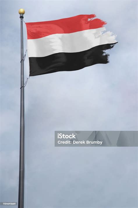 Flag Of Yemen With A Torn Edge In Front Of A Stormy Sky Stock Photo ...
