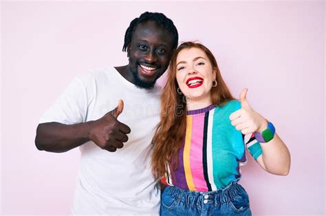 Interracial Couple Wearing Casual Clothes Success Sign Doing Positive