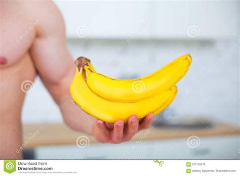 Muscular Man With A Naked Torso In The Kitchen With Fruit Concept Of Healthy Eating Athletic