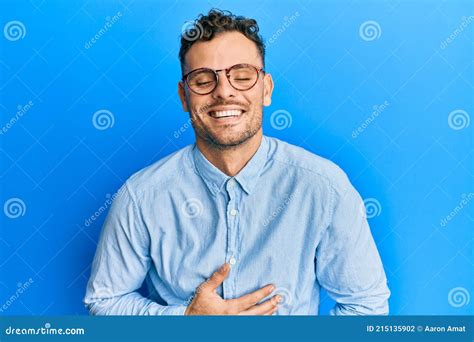 Young Hispanic Man Wearing Casual Clothes And Glasses Smiling And