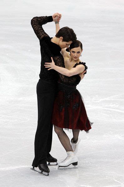 Two People Are Skating On An Ice Rink And One Has Her Arm Around The