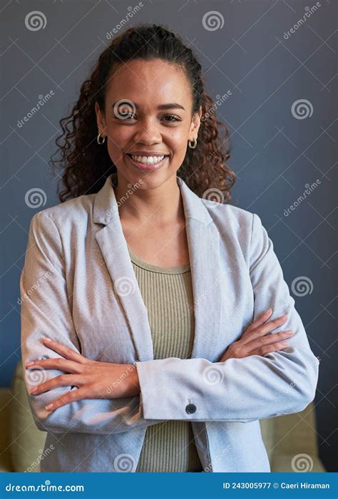 A Young Business Woman Stands With Her Arms Crossed In A Portrait Pose