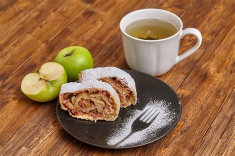 Premium Photo Apple Strudel With Icing Sugar On Black Plate