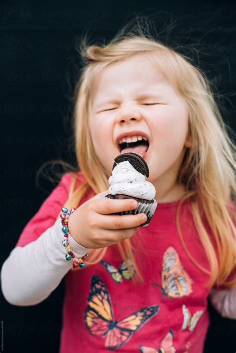 "Food: Little Girl Eating A Cookie Cupcake" by Stocksy Contributor "Ina ...