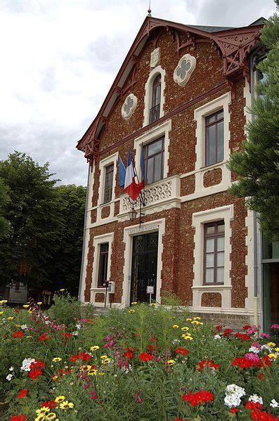 An Old Building With Flowers In Front Of It