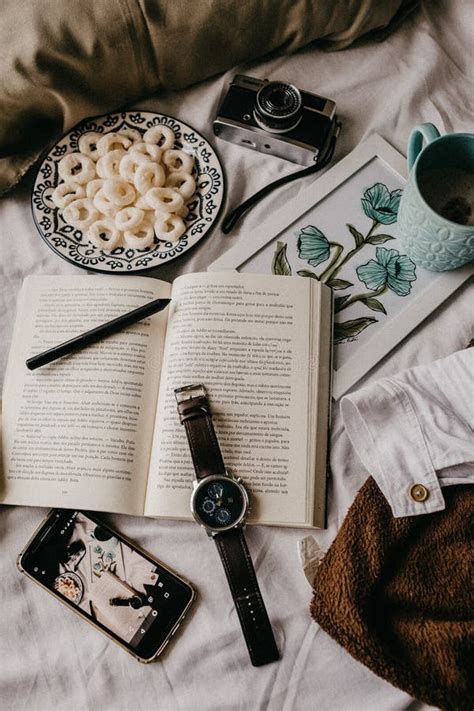 Vertical Top View of an Open Book with a Camera, Coffee, and Snacks on a Bed Stock Photo - Image ...