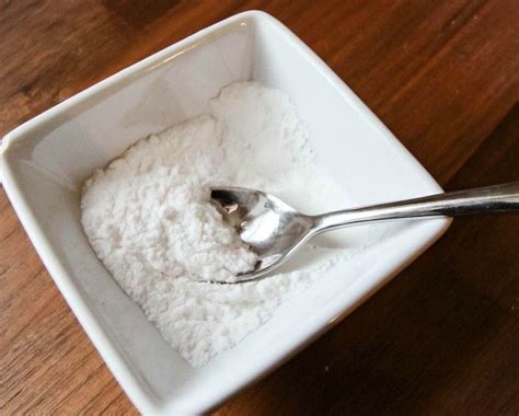 A Spoon In A Bowl Filled With White Powder