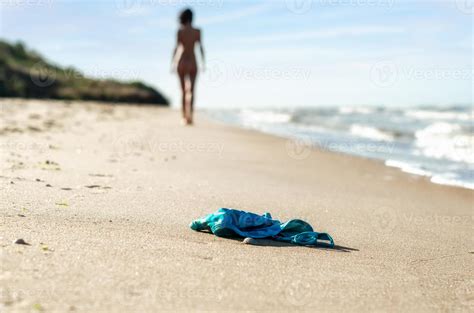 Swimsuit In The Sand On The Beach And Naked Female Figure