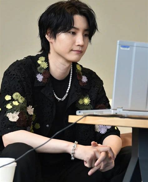 A Woman Sitting At A Desk With A Laptop Computer On Her Lap And Looking