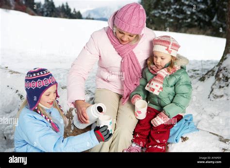 Mother Pouring Hot Tea In Daughter S Cups Stock Photo Alamy
