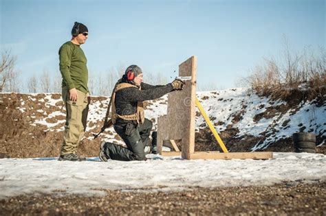 Instructor Teaches Student Tactical Gun Shooting Behind Cover Or