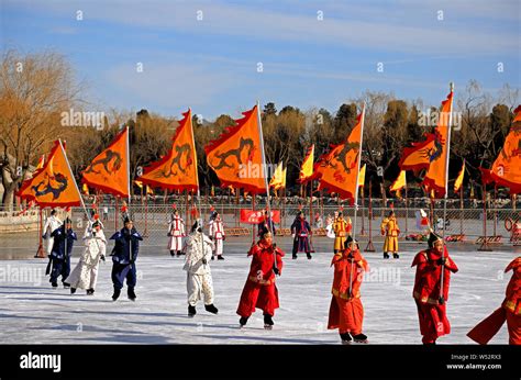 Entertainers dressed in helmets and armor in the style of Manchu warriors from the Qing dynasty ...