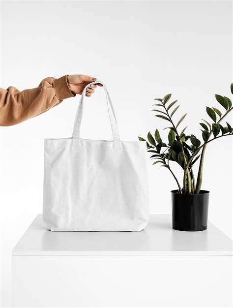 Front View of a Hand Holding Canvas Bag Mockup Free Download | Resource Boy