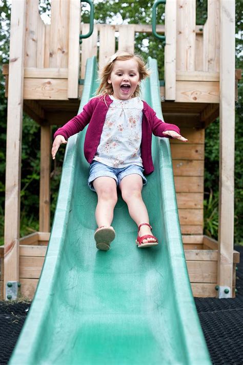 Girl Sliding Down A Slide Photograph by Ian Hooton - Fine Art America
