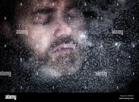 Man dead beneath ice under a frozen lake. Eyes closed with hyporthermia ...