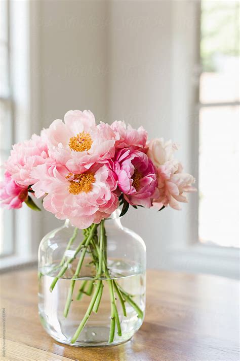 Bouquet Of Pink Peonies In A Glass Vase In A Light Filled Room By