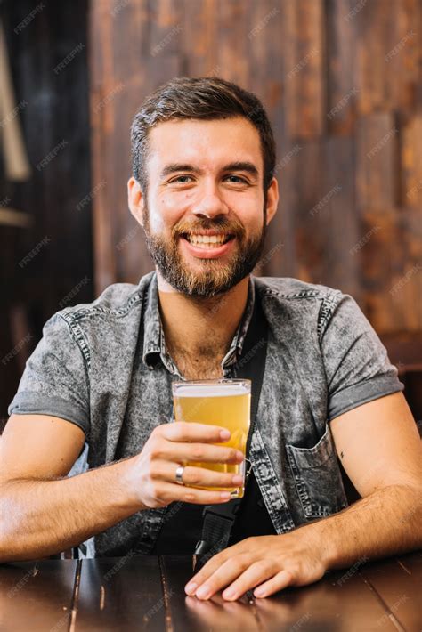 Free Photo Portrait Of A Smiling Man Holding Glass Of Beer