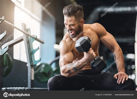 Naked Bodybuilder Exercising With Dumbbell At Gym Stock Photo By Milkos 272287692