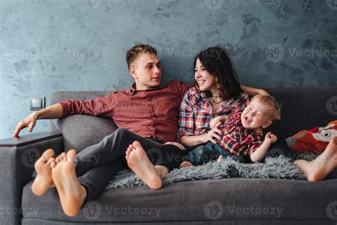 Happy family on the couch 11530697 Stock Photo at Vecteezy