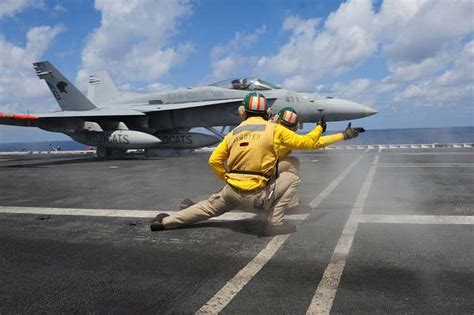 Shooters On The Flight Deck Of The Nimitz Class Aircraft Carrier USS