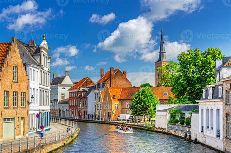Bruges cityscape, Sint Annarei water canal with tourists boat, medieval