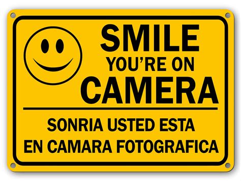 Smile Youre On Camera English Spanish Sign Yellow Plastic X Rust