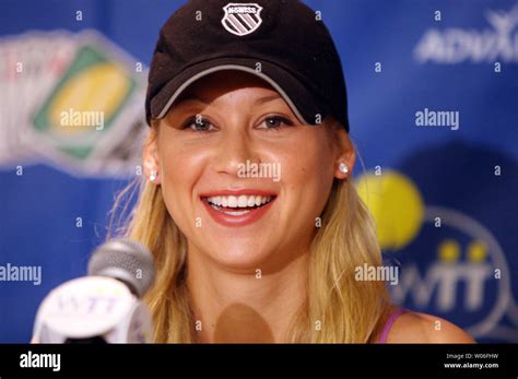 Tennis Star Anna Kournikova Smiles As She Sits Down For A Press