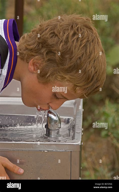 Boy 11 - Drinking from water fountain Stock Photo - Alamy