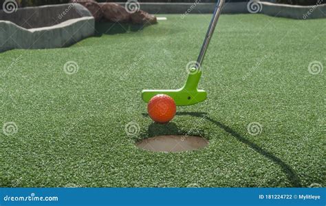 Miniature Golf Putter Tapping Ball Into Hole Stock Photo Image Of