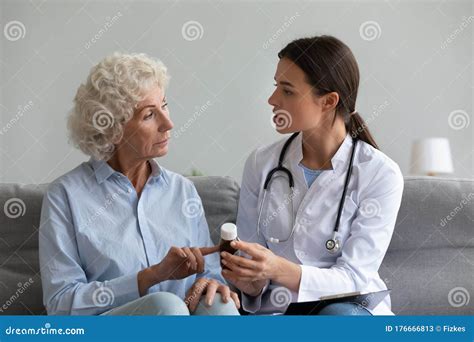 Female Doctor Consult Senior Patient About Medicine Prescription Stock