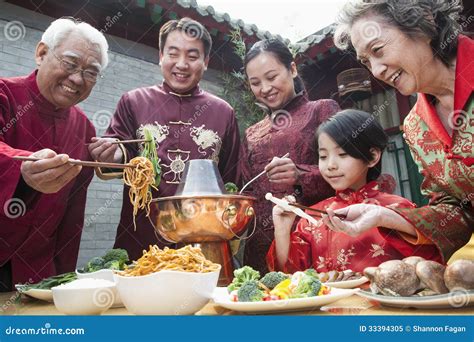 Family Enjoying Chinese Meal In Traditional Chinese Clothing Royalty ...