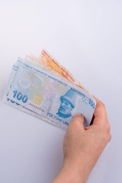 Premium Photo Cropped Hand Holding Paper Currency Against White