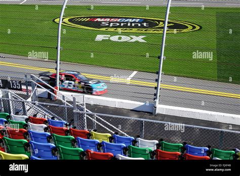 Daytona International Speedway seats, track, grassy area with sign for Nascar sprint cup series ...