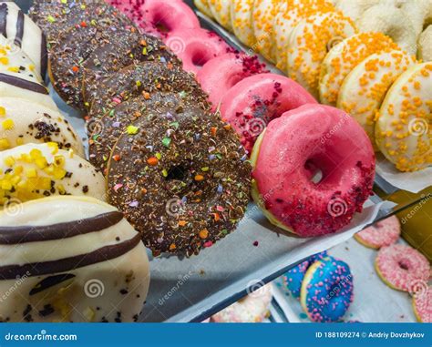 Multi Colored Donuts Lie In A Row On A Shop Window Stock Photo Image