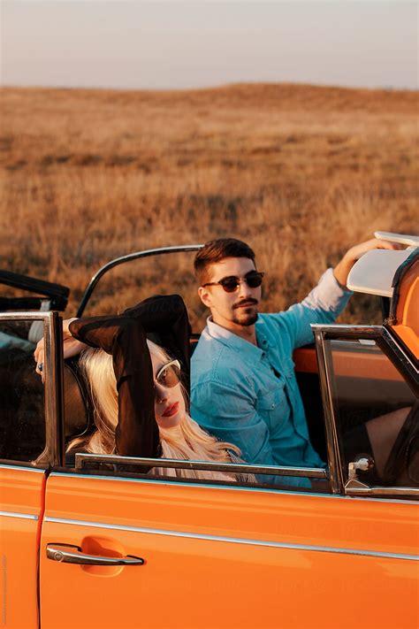 Couple In A Convertible Car On A Road Trip In Nature By Stocksy Contributor Alexandra Bergam