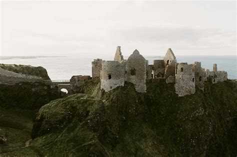 old medieval ruins of Dunluce Castle on ocean coast in northern Ireland ...