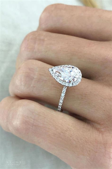 Perfectly Designed With A Gorgeous Pear Shape Diamond Center Adorned