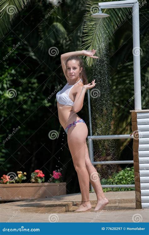 Girl Wear Bikini Standing Under The Outdoor Pool Shower Stock Image