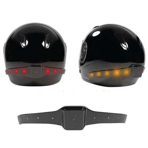 Two Black Helmets With Red Lights On Them