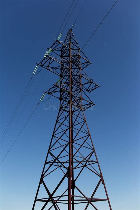 Metal Electric Tower Of High Voltage On Background Of Blue Sky Stock