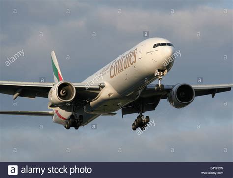 Emirates Boeing 777-300 landing at sunset Stock Photo - Alamy