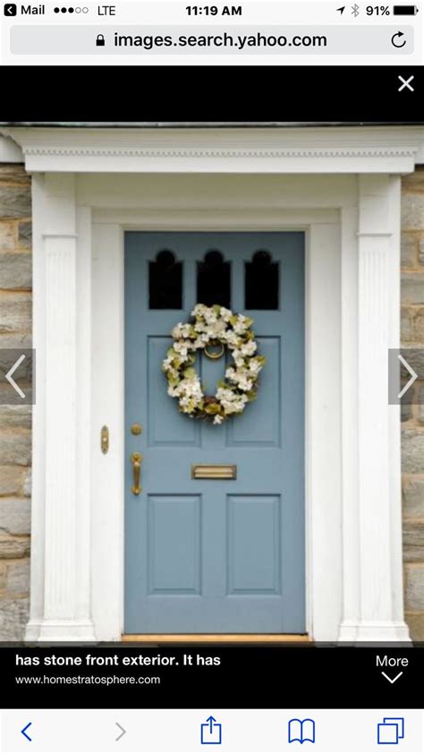 A Blue Front Door With A Wreath On It