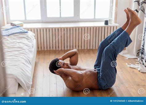 Naked To The Weist Athlete Lying On The Floor With Raised Legs Stock Photo Image Of Healthy