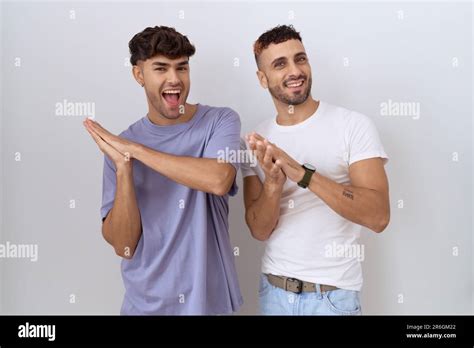 Homosexual Gay Couple Standing Over White Background Clapping And Applauding Happy And Joyful