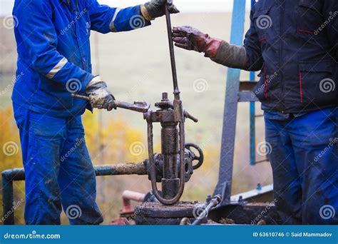 Oil Workers Check Oil Pump Roustabouts Doing Dirty And Dangerous Work