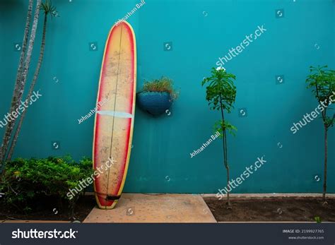 Surfboard Leaning On Bright Green Wall Stock Photo 2199927765