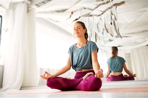 Premium Photo Woman Meditating In Lotus Pose At Yoga Studio