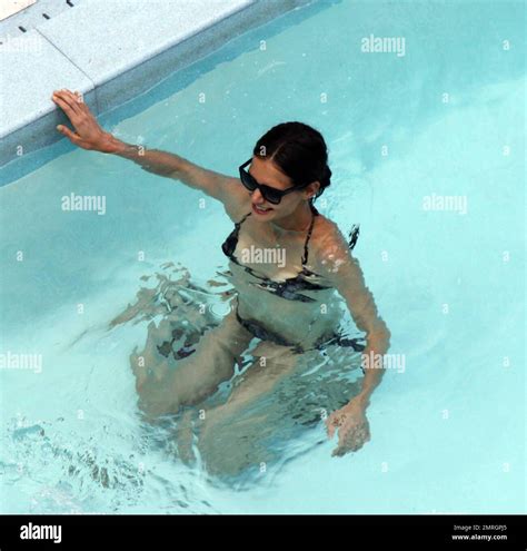 Katie Holmes Shows Off Her Slender Figure In A Black Bikini As She Relaxes Poolside In Miami FL